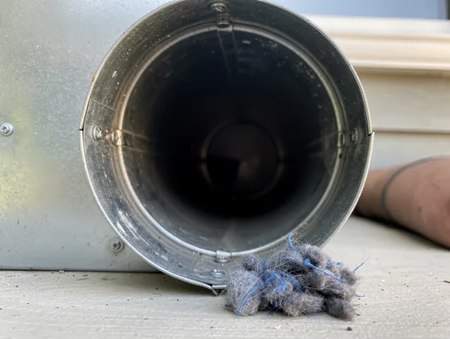 Clearwater Dryer Vent Cleaning technician using specialized equipment to clear severe dryer vent blockage in Clearwater